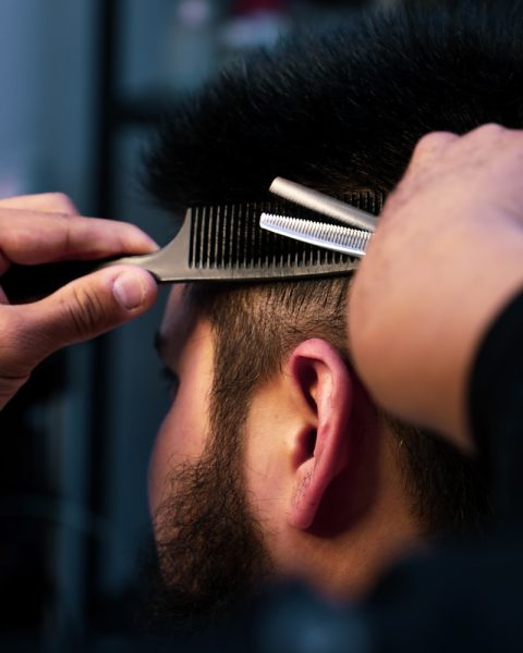 a man with a beard and a hair clipper on his head