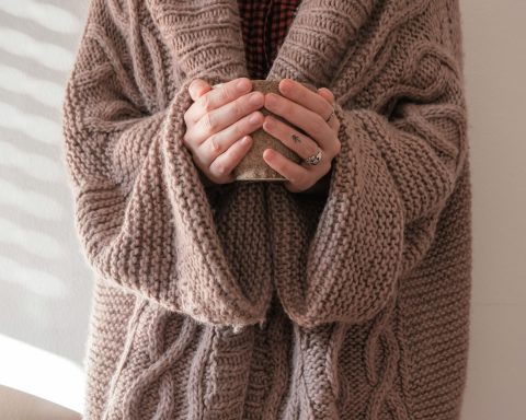 person in brown knit sweater