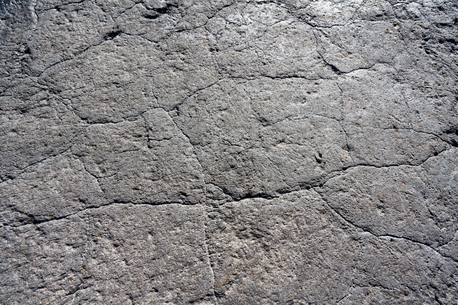 a close up of a rock surface with small cracks