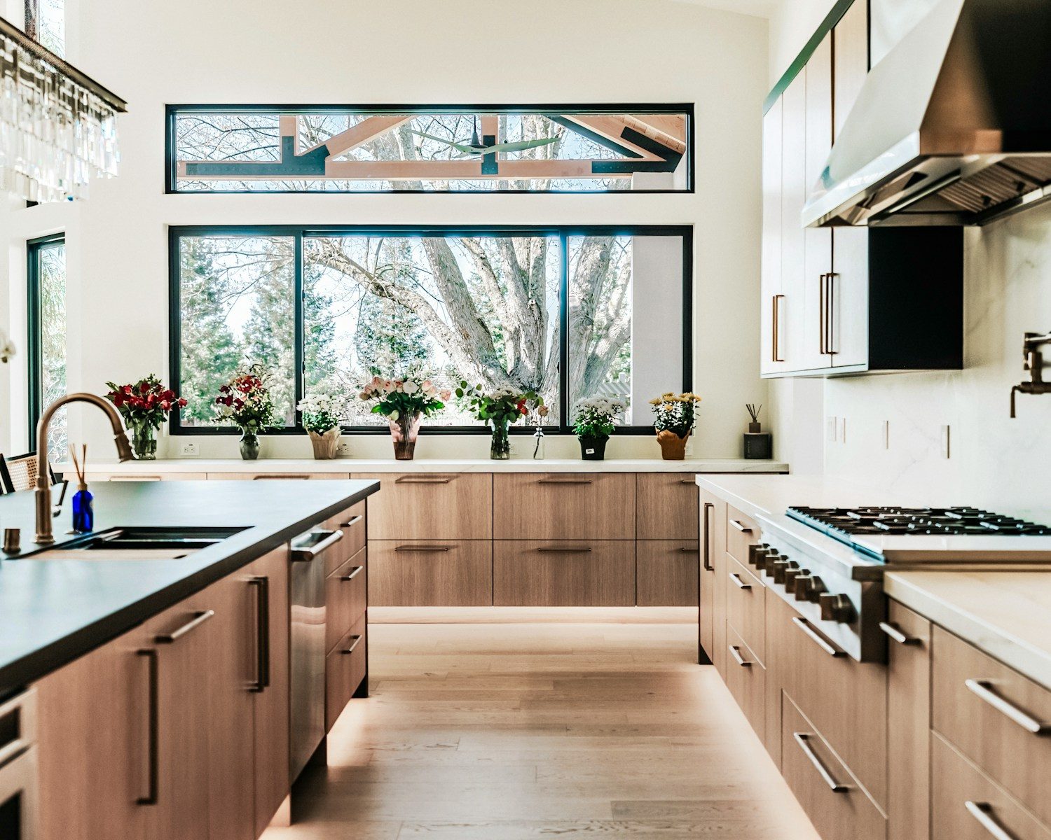 Modern kitchen with wood cabinets and large windows
